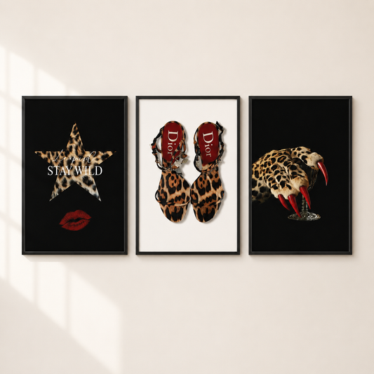 Three framed fashion art prints displayed side-by-side on a light beige wall. The left print features a leopard-print star with the text 'STAY WILD' and red lips on a black background.