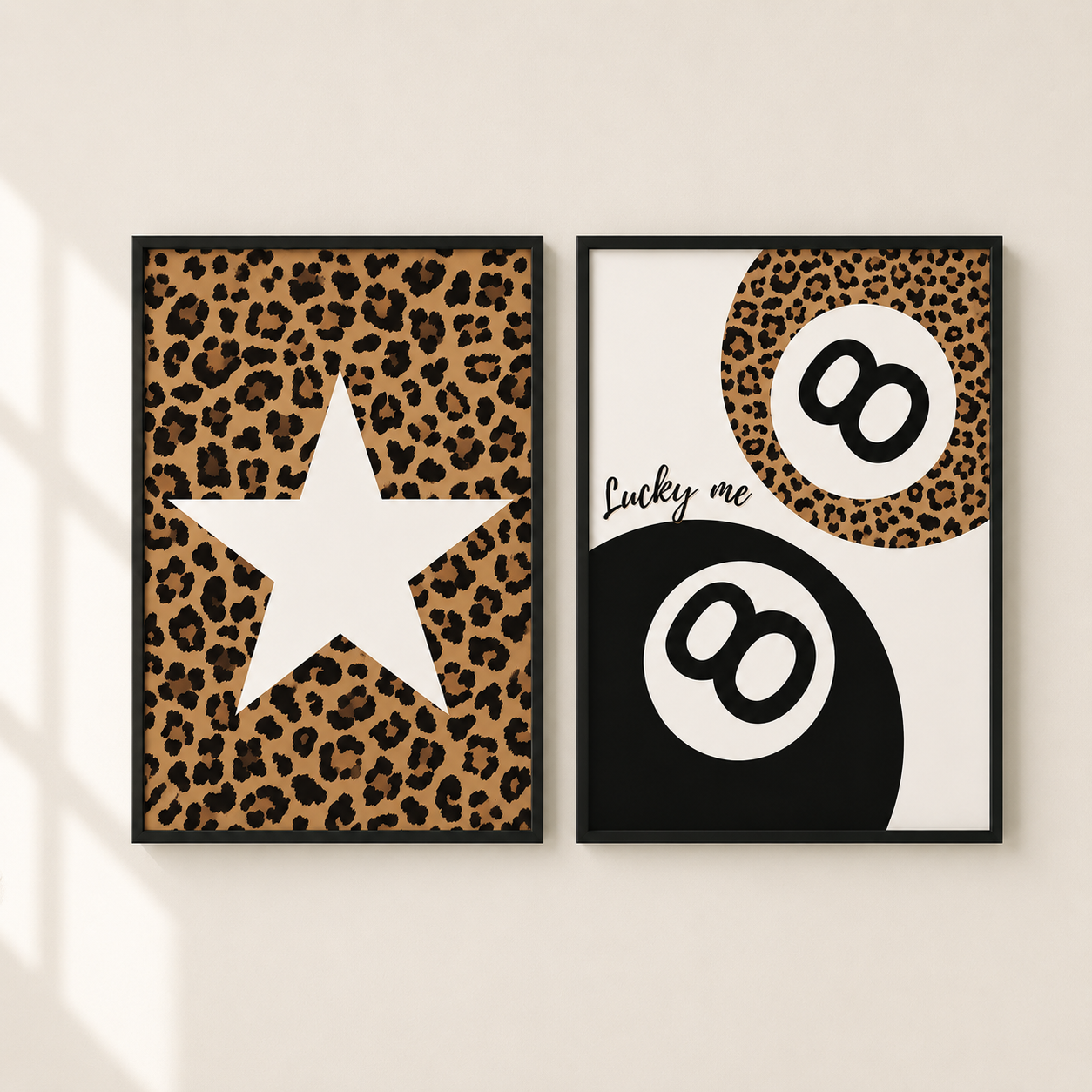 Two framed wall art prints with black frames hang on a light beige wall. The left print features a leopard print background with a large white star.