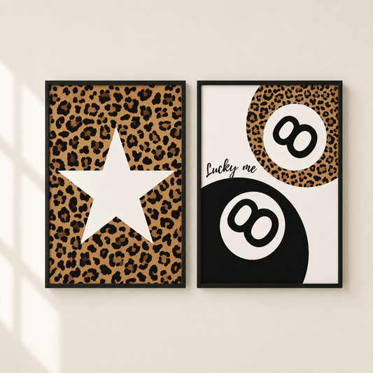 Two framed wall art prints with black frames hang on a light beige wall. The left print features a leopard print background with a large white star.