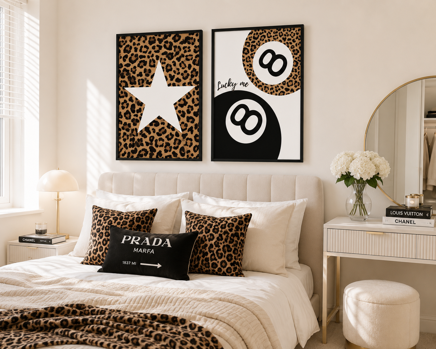 A styled bedroom interior with two framed wall art prints above a bed. The prints feature leopard print backgrounds: one with a large white star and the other with a black-and-white billiard ball motif and the words 'Lucky me.