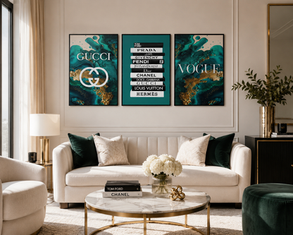 A styled living room featuring a three-panel framed wall art set with luxury logos and names including Gucci, Prada, Fendi, Chanel, Louis Vuitton, and Hermès. The artwork has a dark teal and gold abstract background with white text and logos.