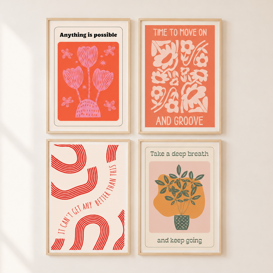 Four framed art prints arranged in a 2x2 grid on a light beige wall. The prints feature minimalist retro-style illustrations in coral, pink, cream, and green with motivational text such as 'Anything is possible,' 'Time to move on and groove,' 'I can't get any better than this,' and 'Take a deep breath and keep going.
