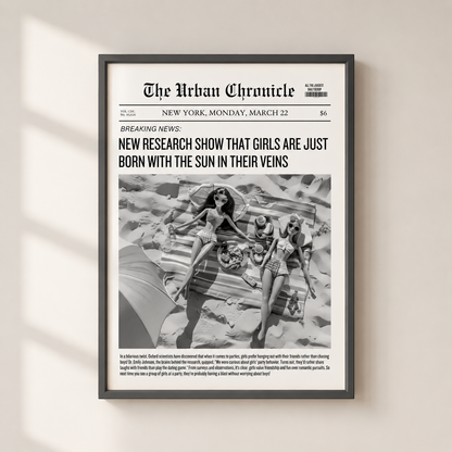A framed black-and-white newspaper-style art print titled "The Urban Chronicle" hangs on a light beige wall. The print features a bold headline and a central photograph of three women on a beach, with smaller text below.