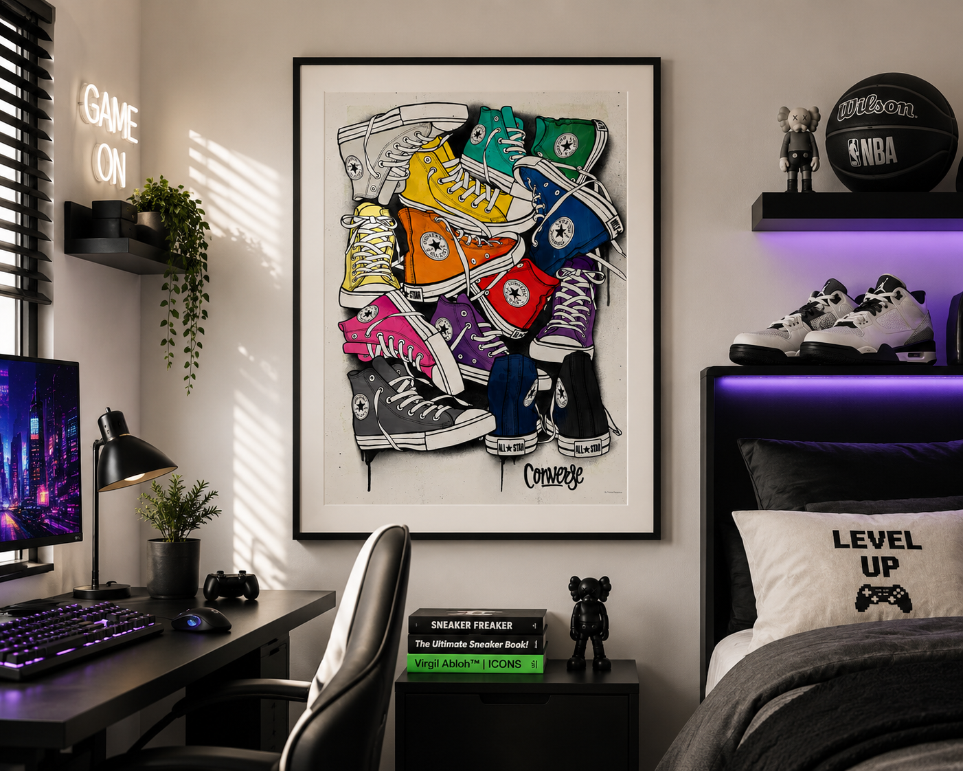 A framed wall art print featuring a colorful collage of classic high-top sneakers hangs on a bedroom wall above a desk and bed. The room includes a desk setup with a keyboard, monitor, lamp, chair, shelving, and decorative items, creating a styled interior scene.