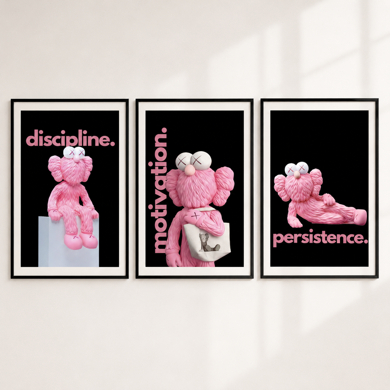 Three framed motivational posters featuring a pink plush bear character on a black background with the words 'discipline.', 'motivation.