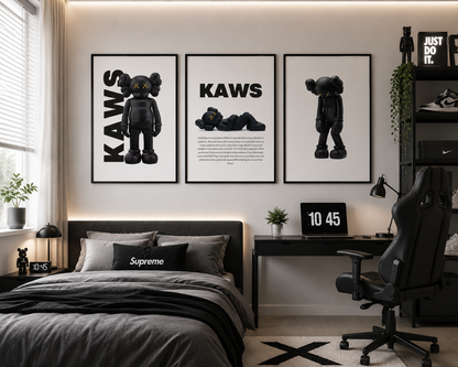 A styled bedroom interior featuring three framed black-and-white 'KAWS' wall art prints above a bed. The room includes a desk, black gaming chair, shelving, plants, and a window with blinds.