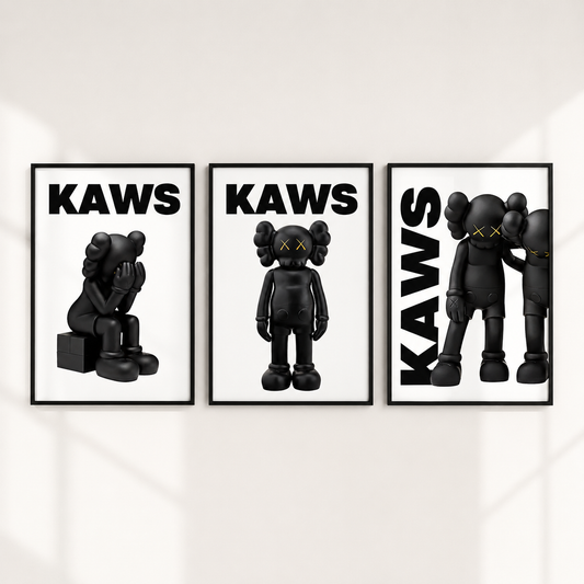 Three framed wall art prints featuring black KAWS character illustrations on a white background, hung side by side on a light wall.