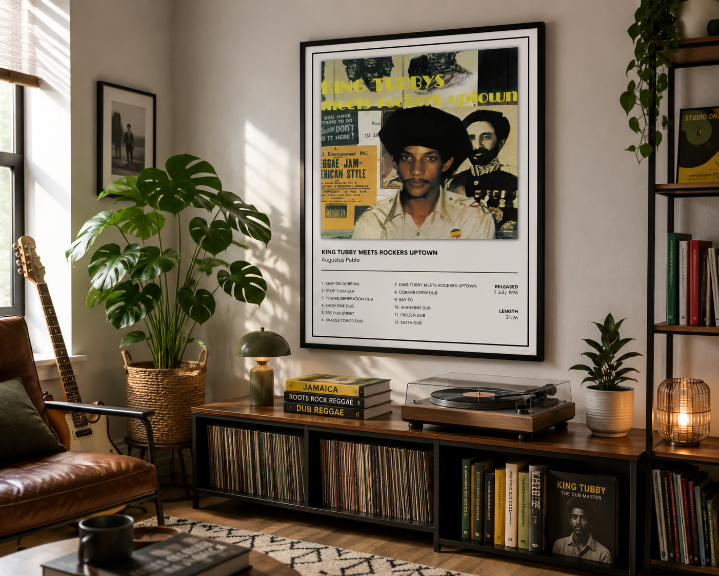 A framed King Tubby 'Augustus Pablo' album poster hangs on a wall in a styled living room with a brown leather armchair, potted plants, a record player, and shelves.