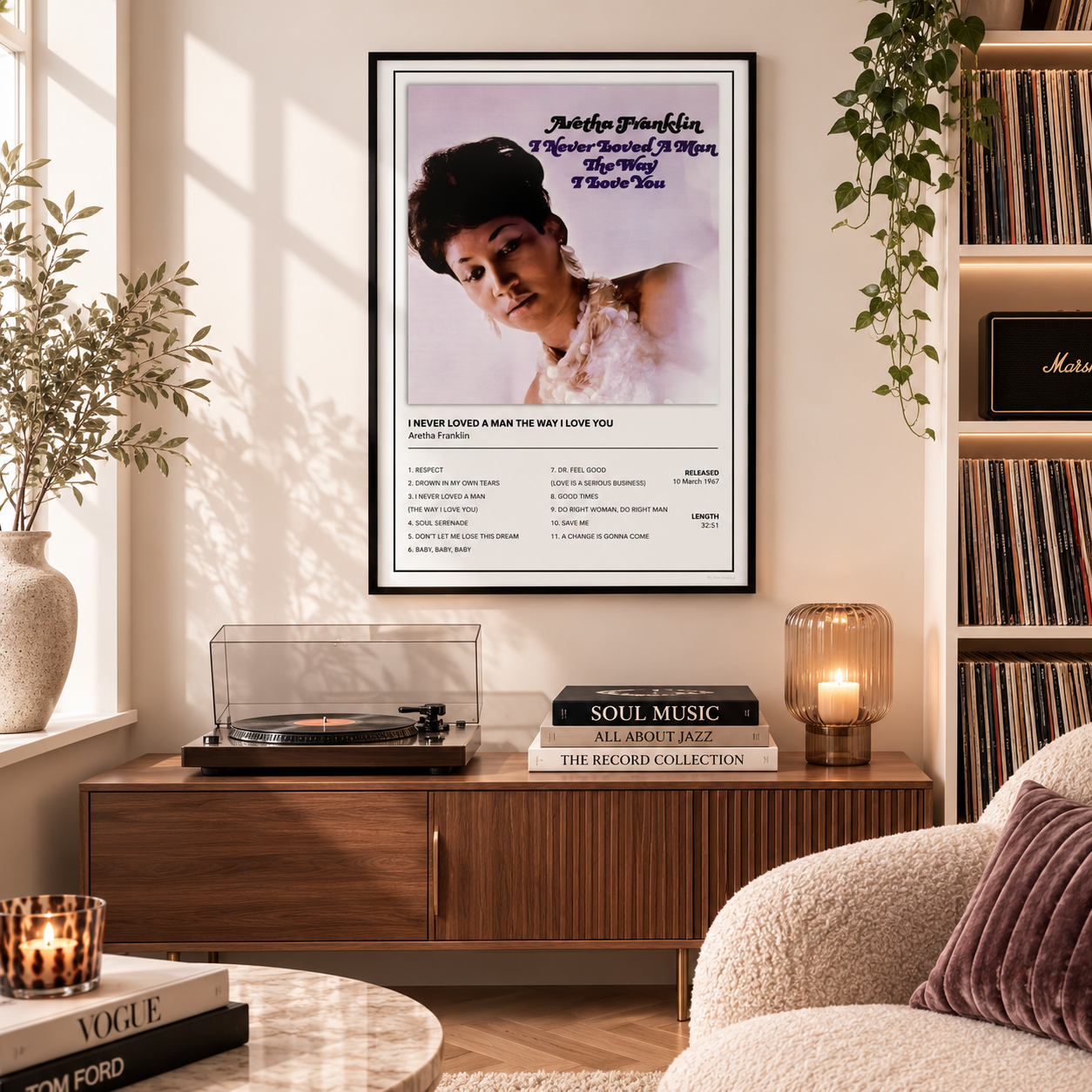 A framed music poster of Madonna's 'True Lie' hanging on a beige wall in a cozy, sunlit record store or living room. The poster features a portrait of Madonna with the song's lyrics printed below.