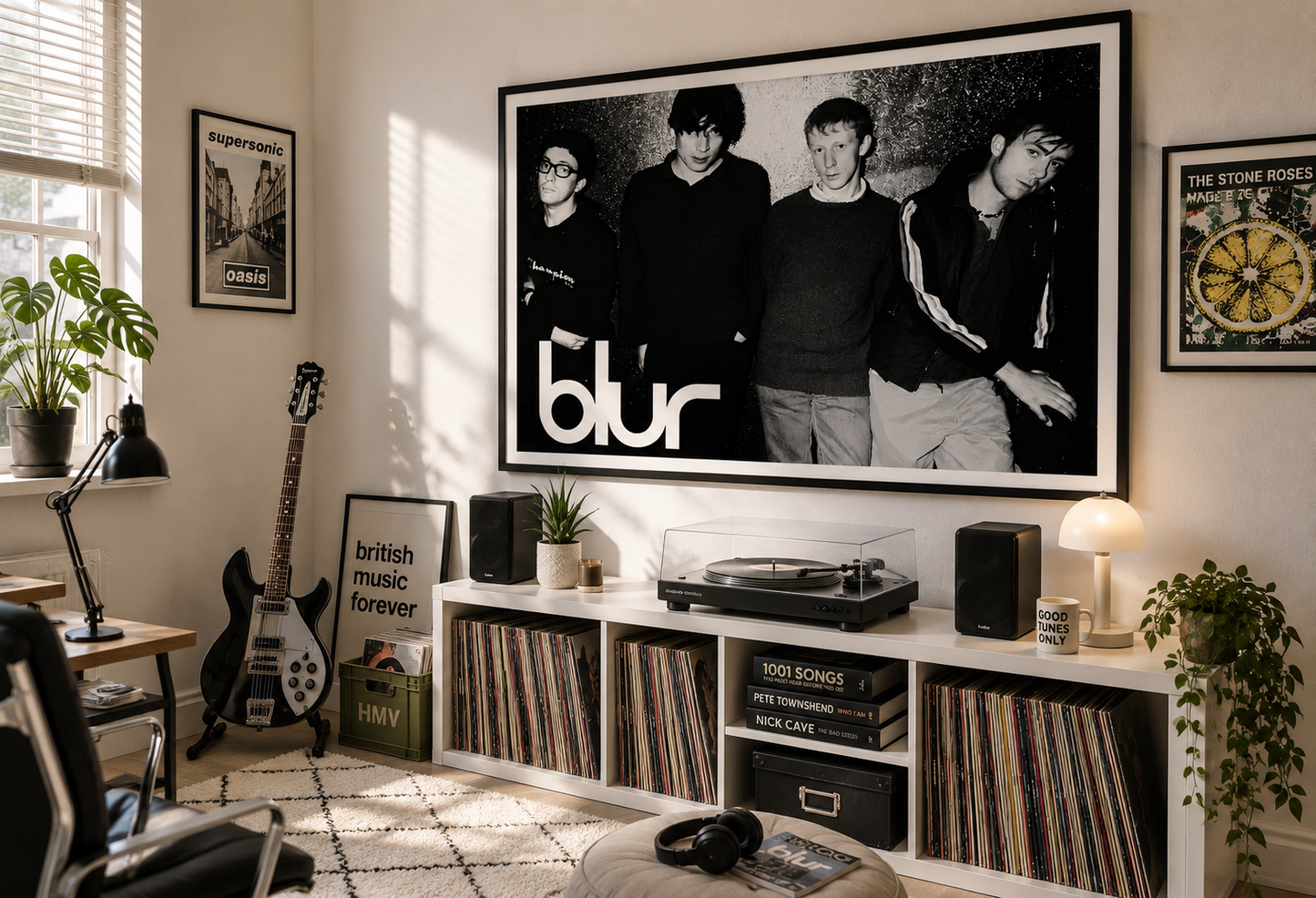 A large black and white framed wall art print of the band Blur is displayed in a modern, sunlit room above a white record cabinet.