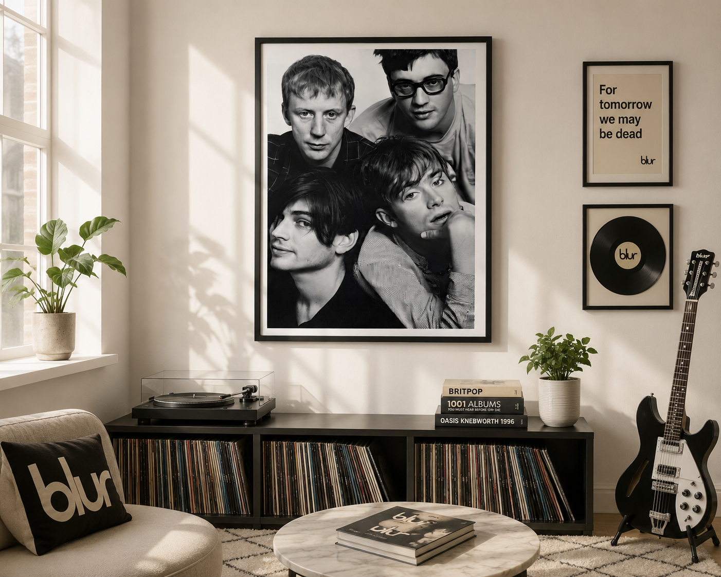A framed black-and-white band poster of Blur hangs on a beige wall in a styled living room. The room features a matching throw pillow, a record console filled with vinyl records, a guitar, and other framed wall art.