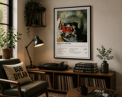 A framed Bob Dylan 'Bringing it All Back Home' album poster hangs on a beige wall in a styled room with a wooden record console, plants, a lamp, and a chair with a 'Bob Dylan' pillow.