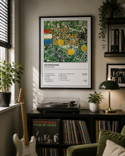 A framed The Stone Roses 'Top Songs Sold Out' poster hangs on a wall in a styled room with a record player, plants, books, and a guitar.