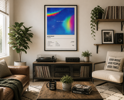 Coldplay Moon Music wall art displayed above a modern record player in a stylish music-themed living room with natural wood and neutral furnishings.
