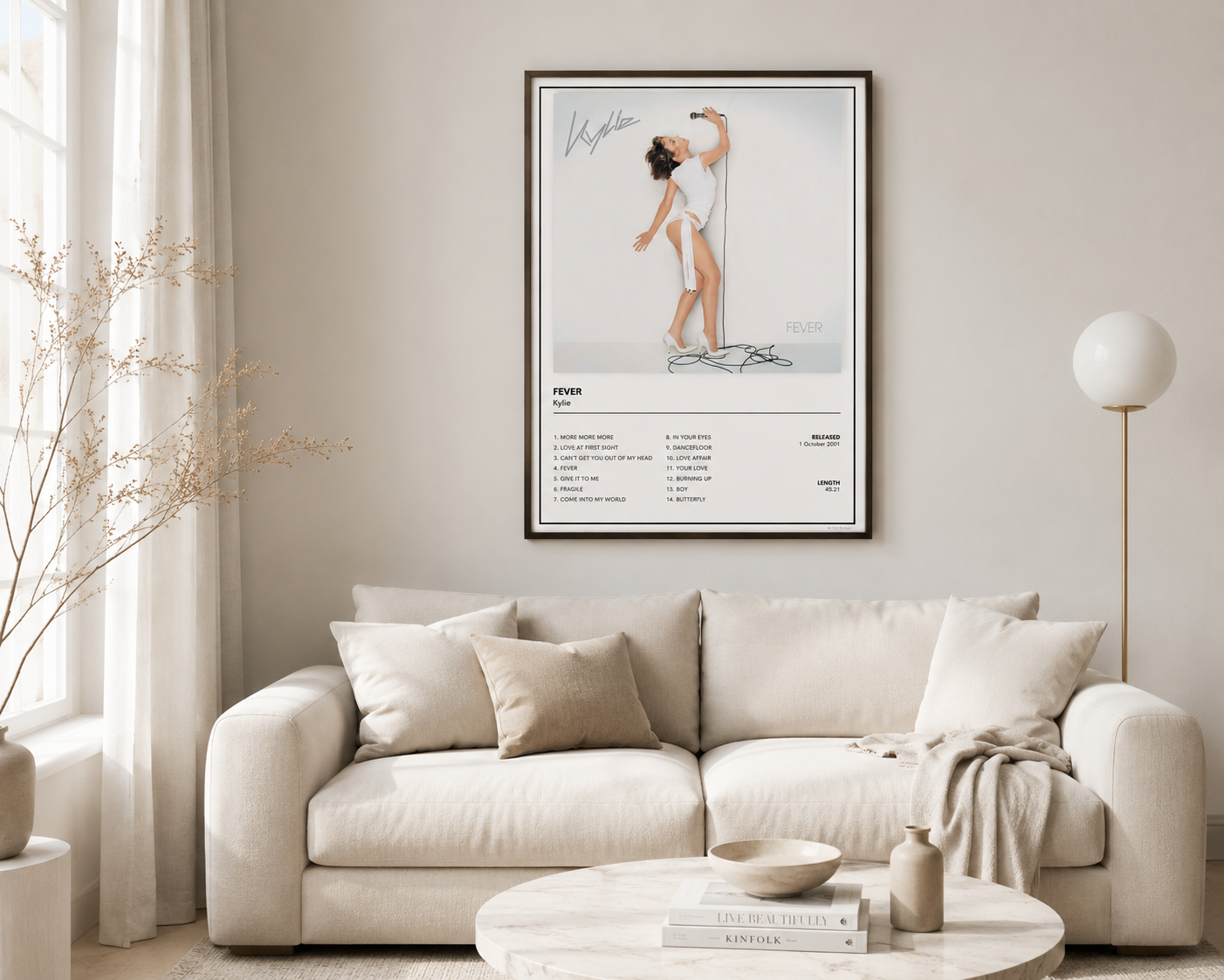 Framed Kylie Minogue Fever music poster hanging above a wooden sideboard in a bright Scandinavian-inspired bedroom, creating a stylish pop music feature wall with minimalist décor.
