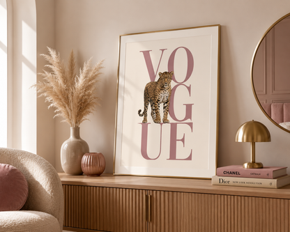 Framed leopard wall art with blush pink typography styled in an elegant feminine vanity room with warm neutral tones.
