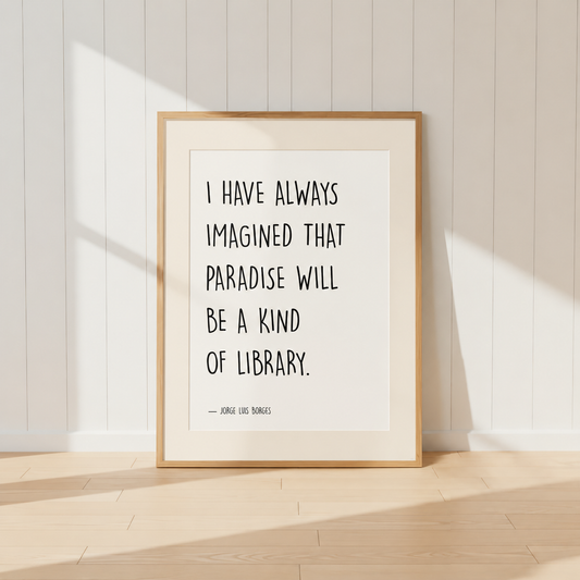 Minimalist Jorge Luis Borges quote print featuring the words "I Have Always Imagined That Paradise Will Be A Kind Of Library" in black typography, finished with a soft natural mount and light oak frame, perfect for home libraries and reading rooms.