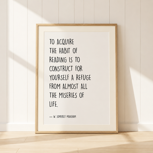 W. Somerset Maugham reading quote print in a light oak frame with a warm ivory mount, styled in a cosy home library with bookshelves and neutral décor.