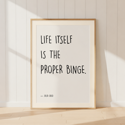 Julia Child quote print with warm ivory mount and light oak frame displayed in a French country kitchen with cookbooks and wooden utensils.