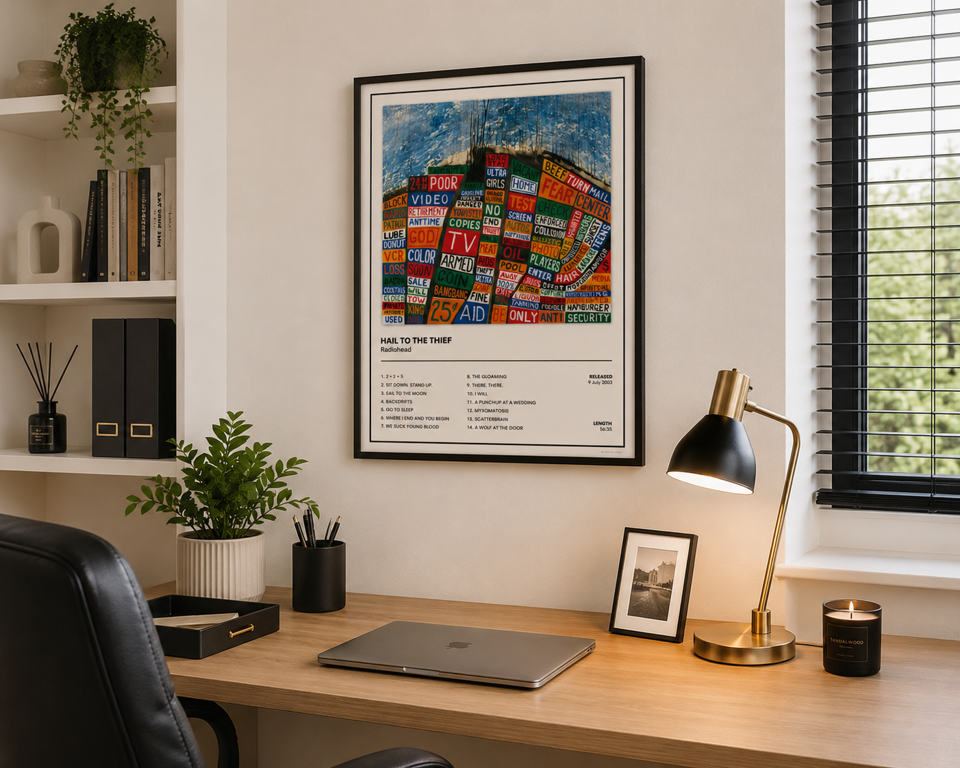 Framed Radiohead Hail To The Thief album cover wall art displayed above a modern home office desk.