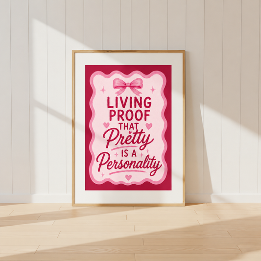 Living Proof That Pretty Is A Personality pink coquette wall art print featuring bow and heart illustrations in a light oak frame.