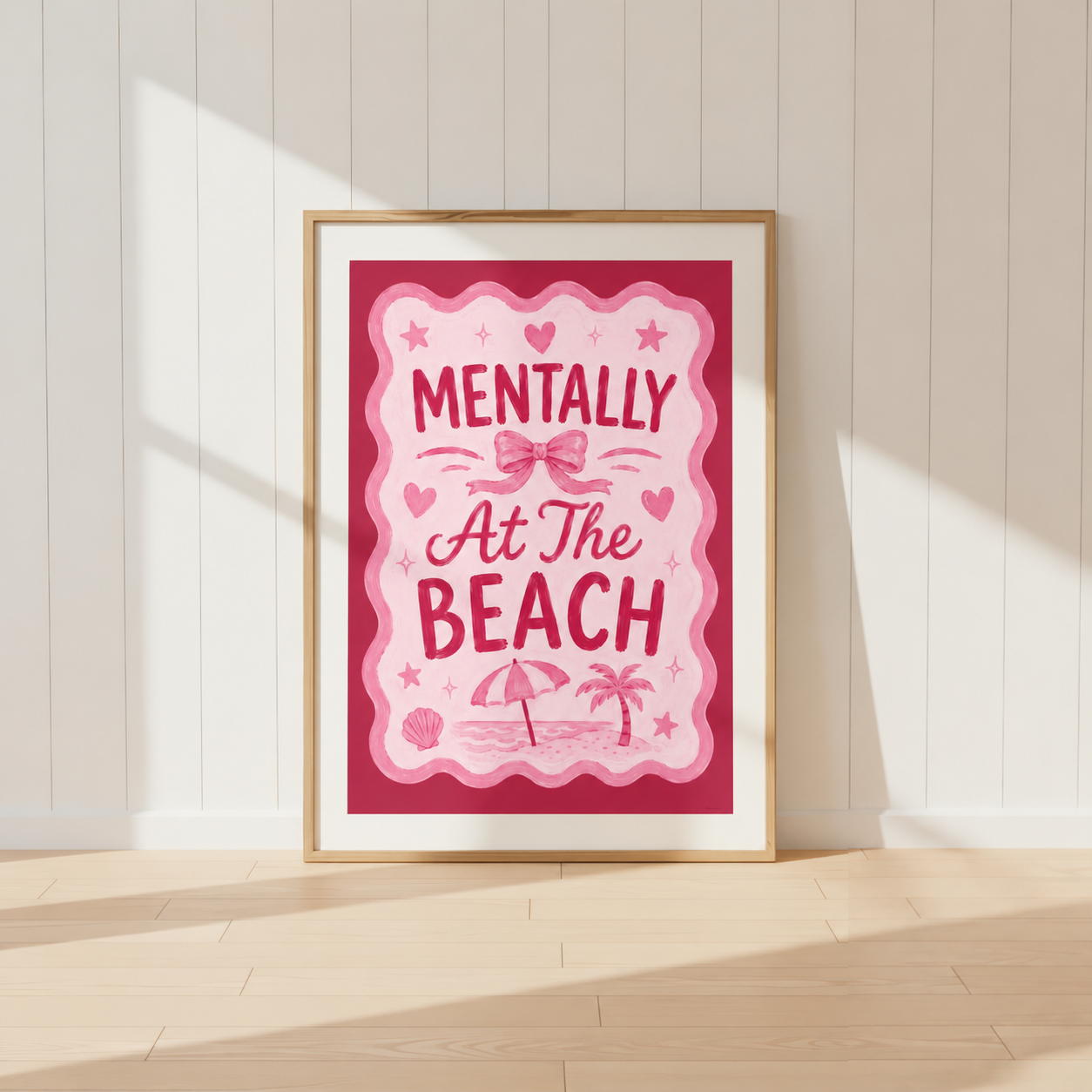 Mentally At The Beach pink coquette wall art print featuring beach umbrella, palm tree and bow illustration in a light oak frame.