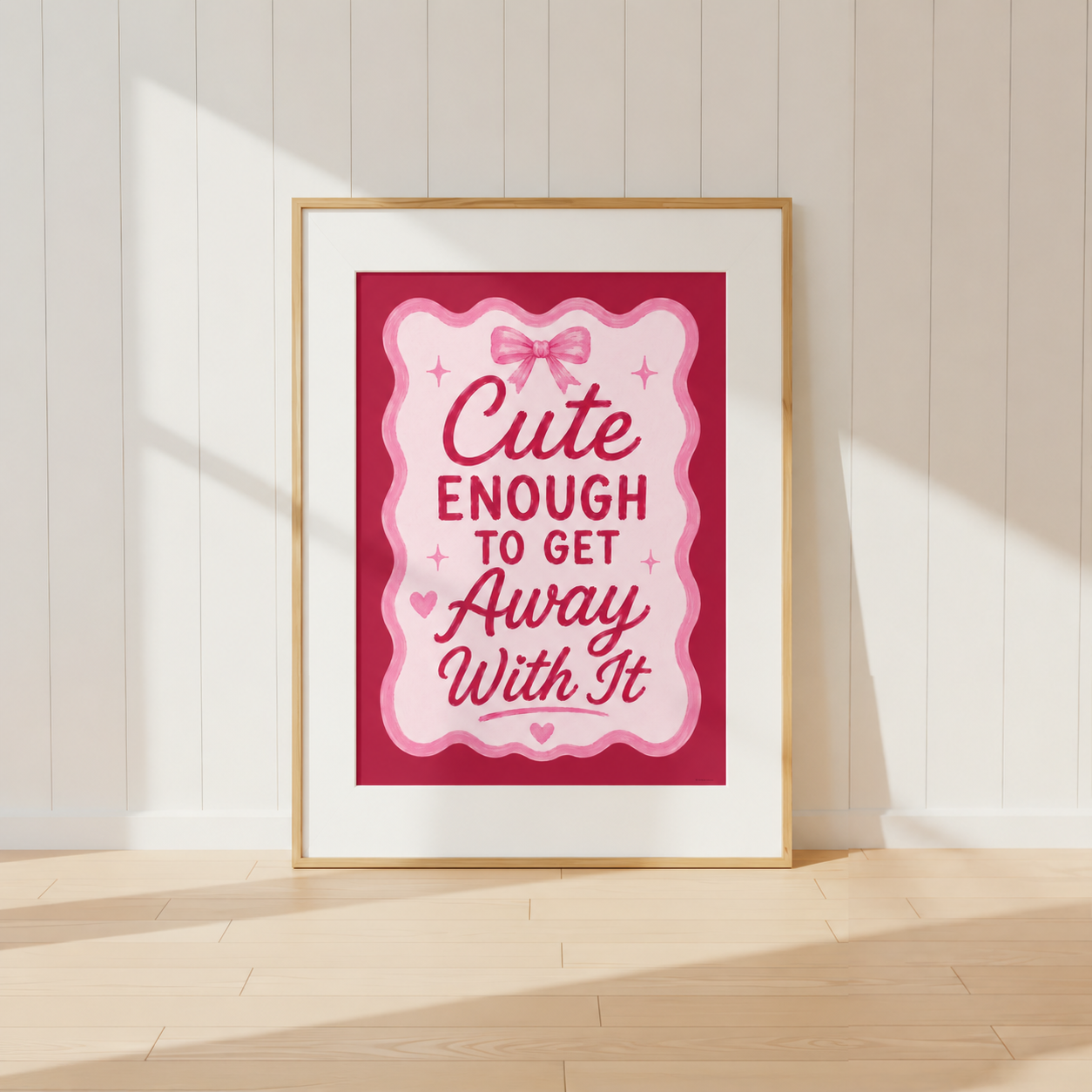 Cute Enough To Get Away With It pink coquette wall art print featuring bow details and feminine typography in a light oak frame.