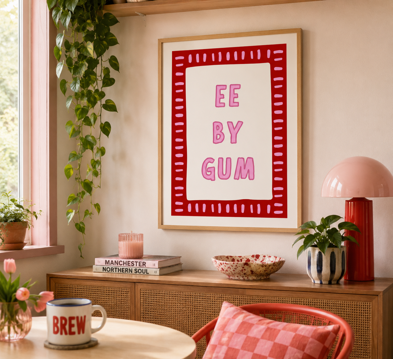 Yorkshire saying typography poster in red and pink displayed in a light oak frame.