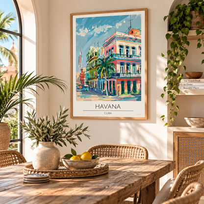 A framed travel poster of Havana, Cuba, hanging on a warm beige wall in a beautifully styled dining room with a wooden table, woven chairs, and potted plants.