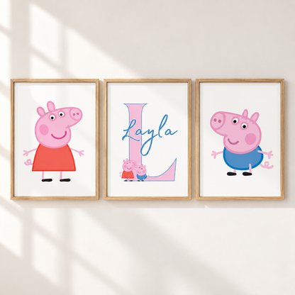 Three framed personalized children's wall art prints hang on a white wall with soft window shadows. The left print shows Peppa Pig in a red dress, the center print features a large letter L with the name Layla in blue script and small Peppa and George illustrations, and the right print shows George Pig in a blue outfit.