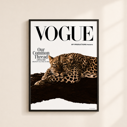 A framed Vogue magazine cover print hangs on a warm off-white wall. The poster features a leopard lying on a dark surface with the large black VOGUE title at the top and smaller text reading 'Our Common Thread' and 'WY PRODUCTIONS presents.