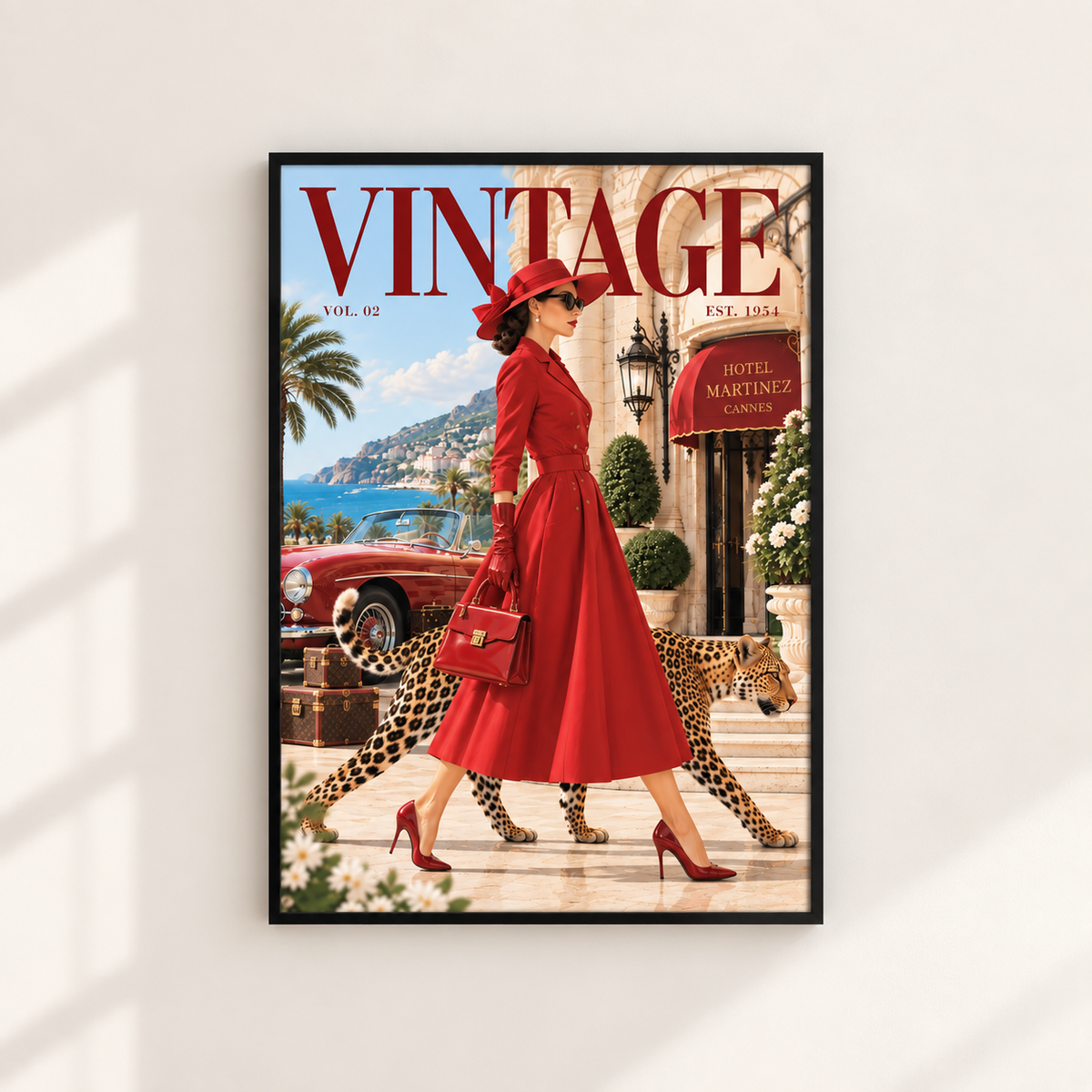 A framed vintage-style art print featuring a woman in a red dress walking with a leopard in front of a Mediterranean building, styled like a retro magazine cover. The print is displayed on a light beige wall with soft window shadows.