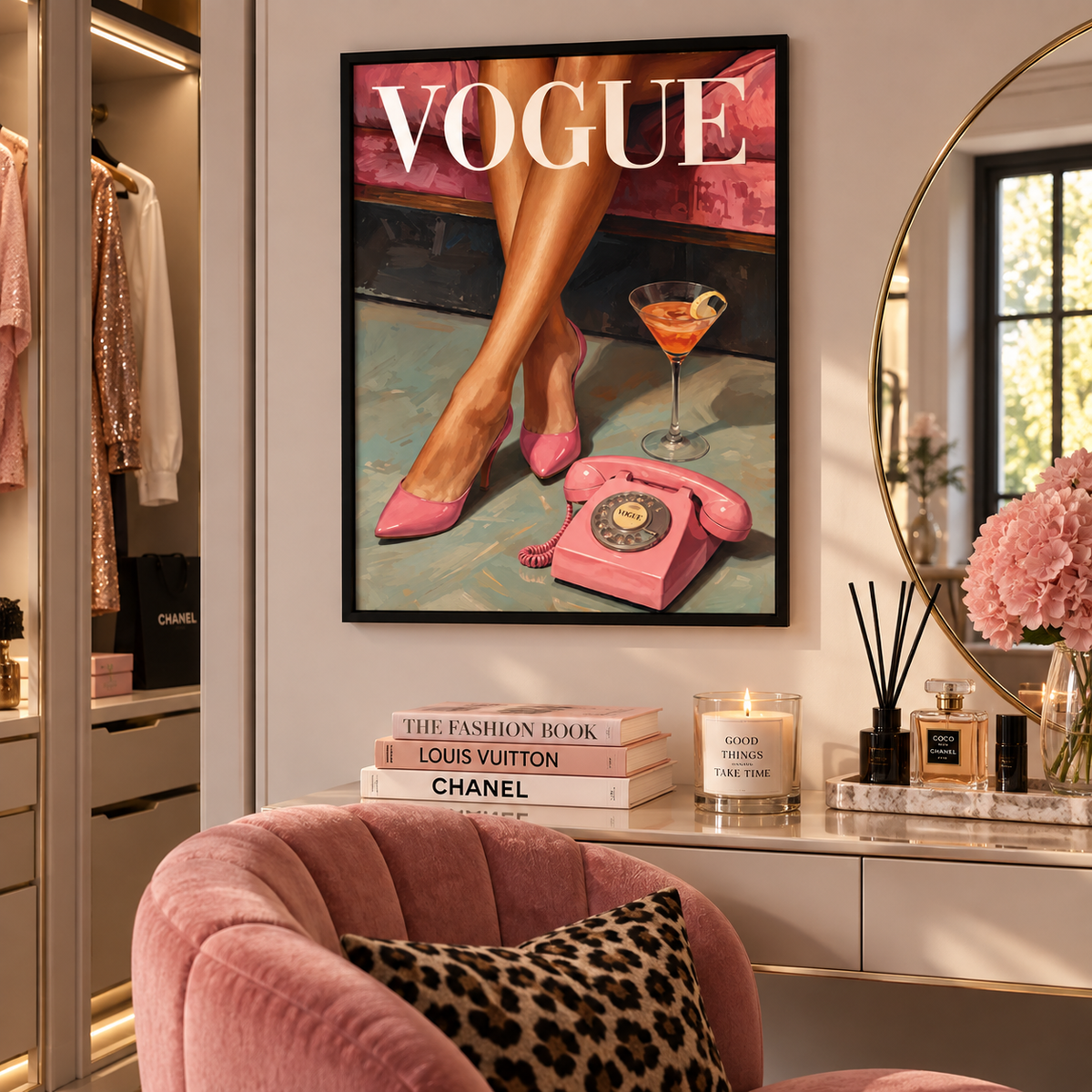 A framed Vogue art print featuring a pink retro rotary phone, pink high heels, and a pink cocktail glass, displayed on a wall in a styled dressing room with a pink velvet chair and Chanel-themed decor.