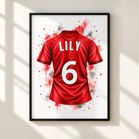 Framed wall art featuring a red soccer jersey back design with the name LILY and number 6 in white, shown hanging on a light wall with soft window shadows.