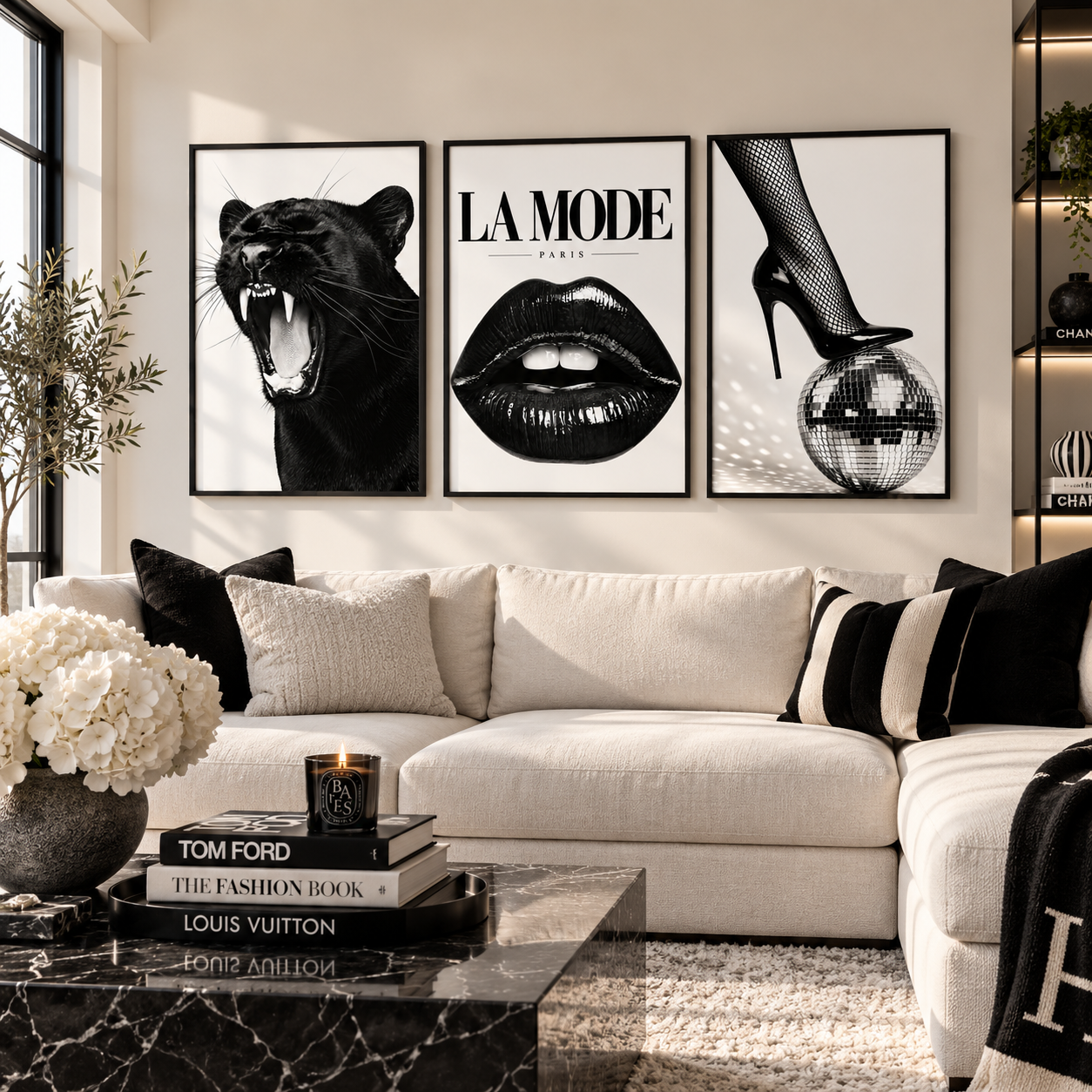 Three framed black and white art prints hang above a cream sectional sofa in a modern living room. The prints feature a roaring black panther, the text 'LA MODE PARIS' above black lips, and a high-heeled foot touching a disco ball.