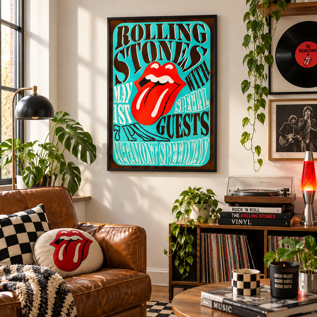 A framed Rolling Stones poster hangs on a wall in a styled living room. The poster features the band's name in bold black text on a bright turquoise background, with the iconic red lips and tongue logo in the center.