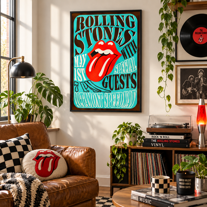 A framed Rolling Stones poster hangs on a wall in a styled living room. The poster features the band's name in bold black text on a bright turquoise background, with the iconic red lips and tongue logo in the center.