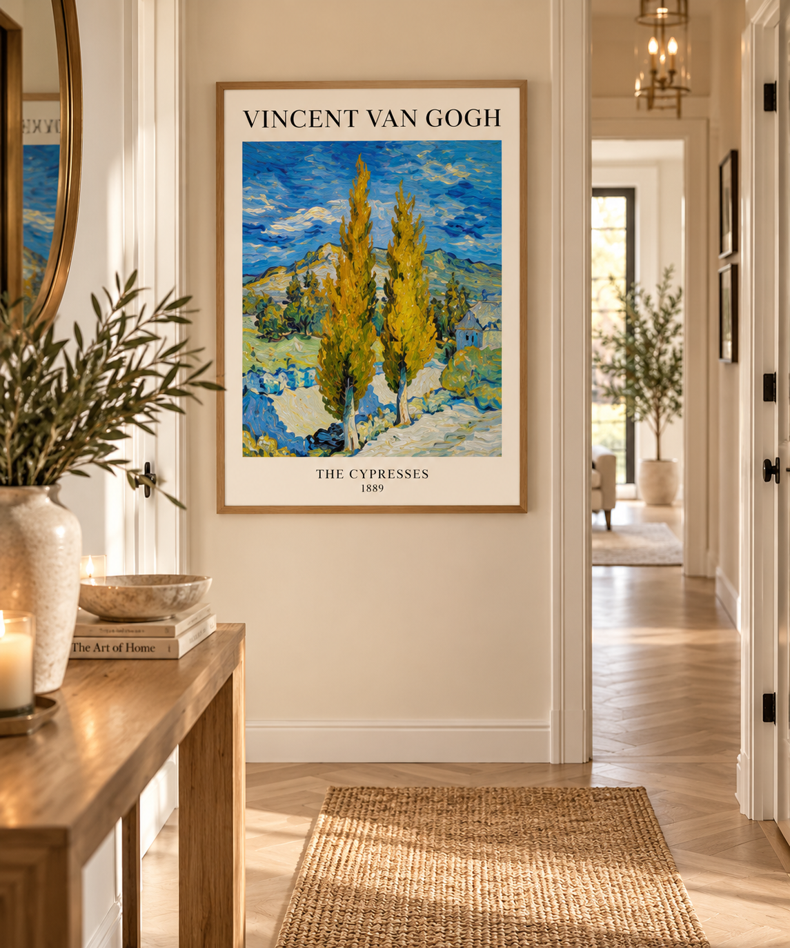 A framed art print of Vincent van Gogh's 'The Cypress' hanging on a cream-colored wall in a bright, modern hallway with wooden floors and a woven rug.