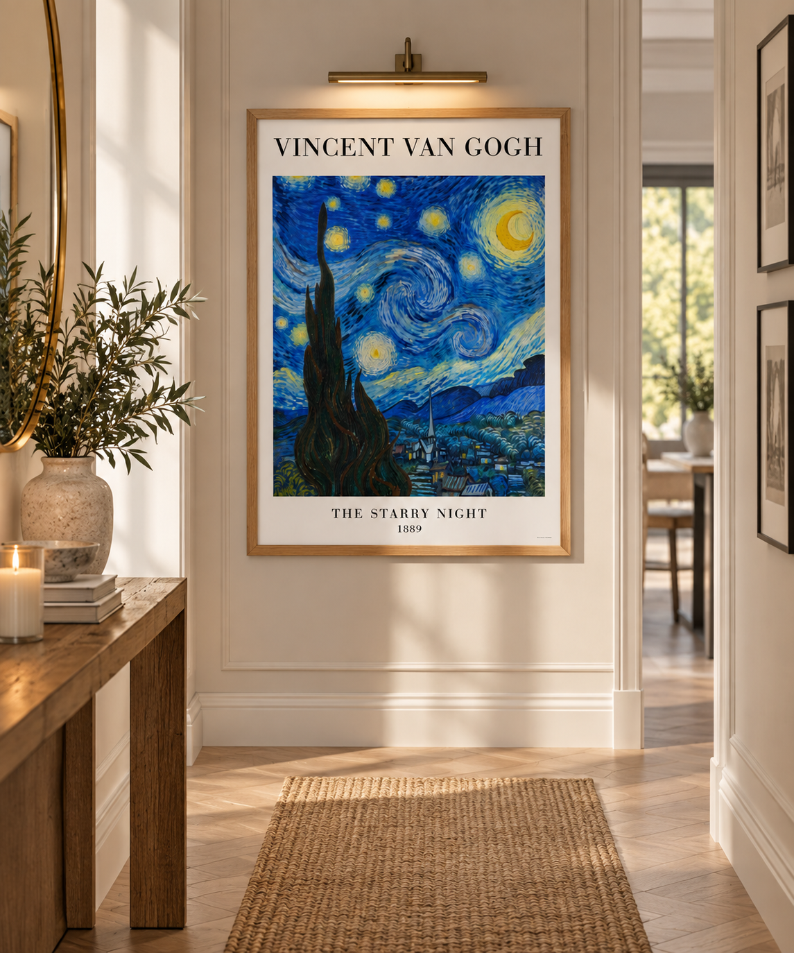 A framed art print of Vincent van Gogh's 'The Starry Night' hanging on a beige wall in a bright, modern hallway with a wooden console table and a woven rug.