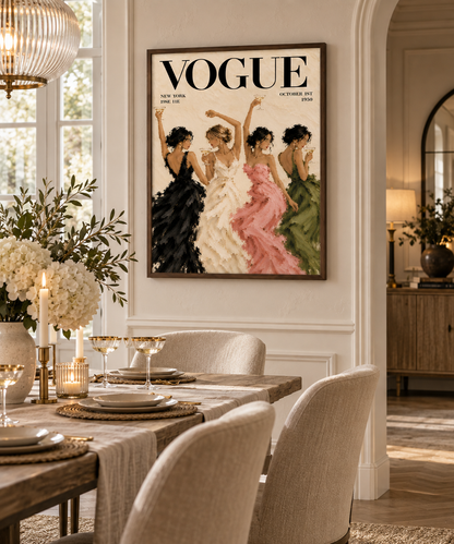A framed Vogue magazine cover art print hangs on a cream wall above a styled dining table with upholstered chairs, candles, and floral arrangements in a bright, elegant interior.