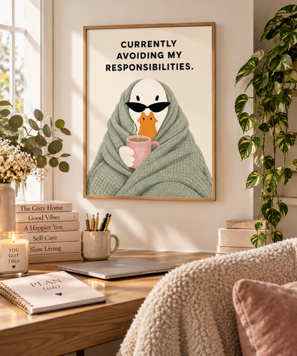 A framed art print featuring a cute cartoon bird wrapped in a green blanket and wearing black sunglasses, holding a pink mug. The text on the print reads 'CURRENTLY AVOIDING MY RESPONSIBILITIES.