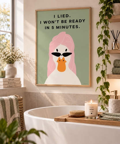 A framed art print featuring a stylized duck with pink hair and black sunglasses, with the text 'I LIED. I WON'T BE READY IN 5 MINUTES.