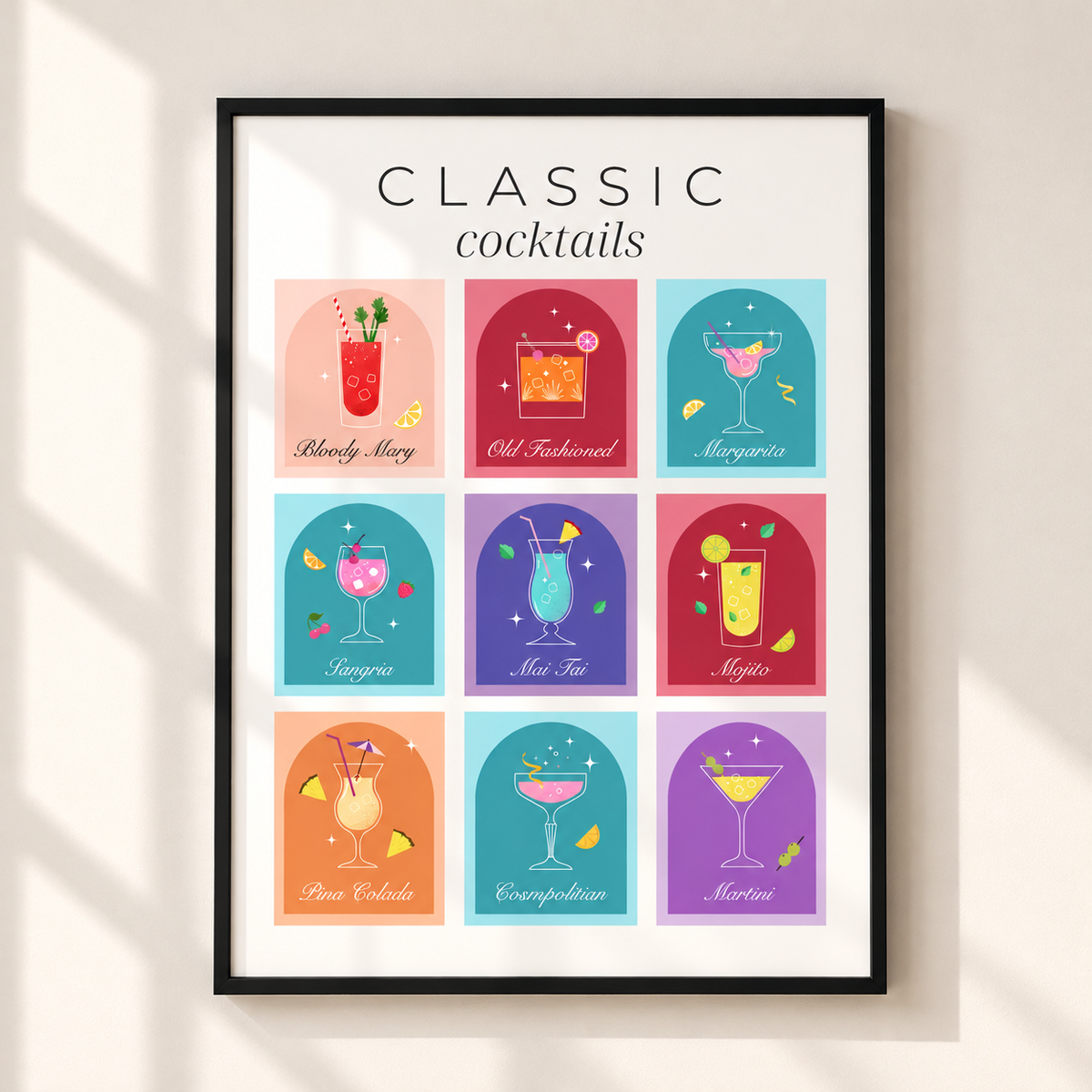 Classic Cocktails colourful retro wall art print featuring nine illustrated drinks in a thin black frame on a warm ivory wall