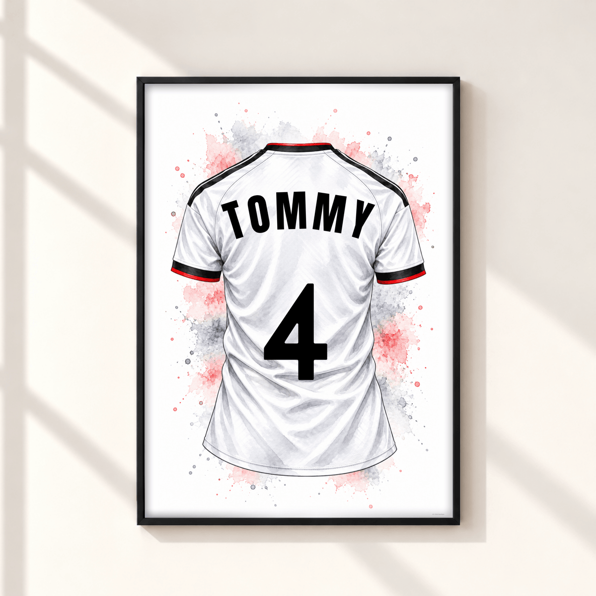 Personalised Fulham inspired football shirt print showing white jersey with TOMMY name and number 4, black red detailing and watercolour splashes in black frame