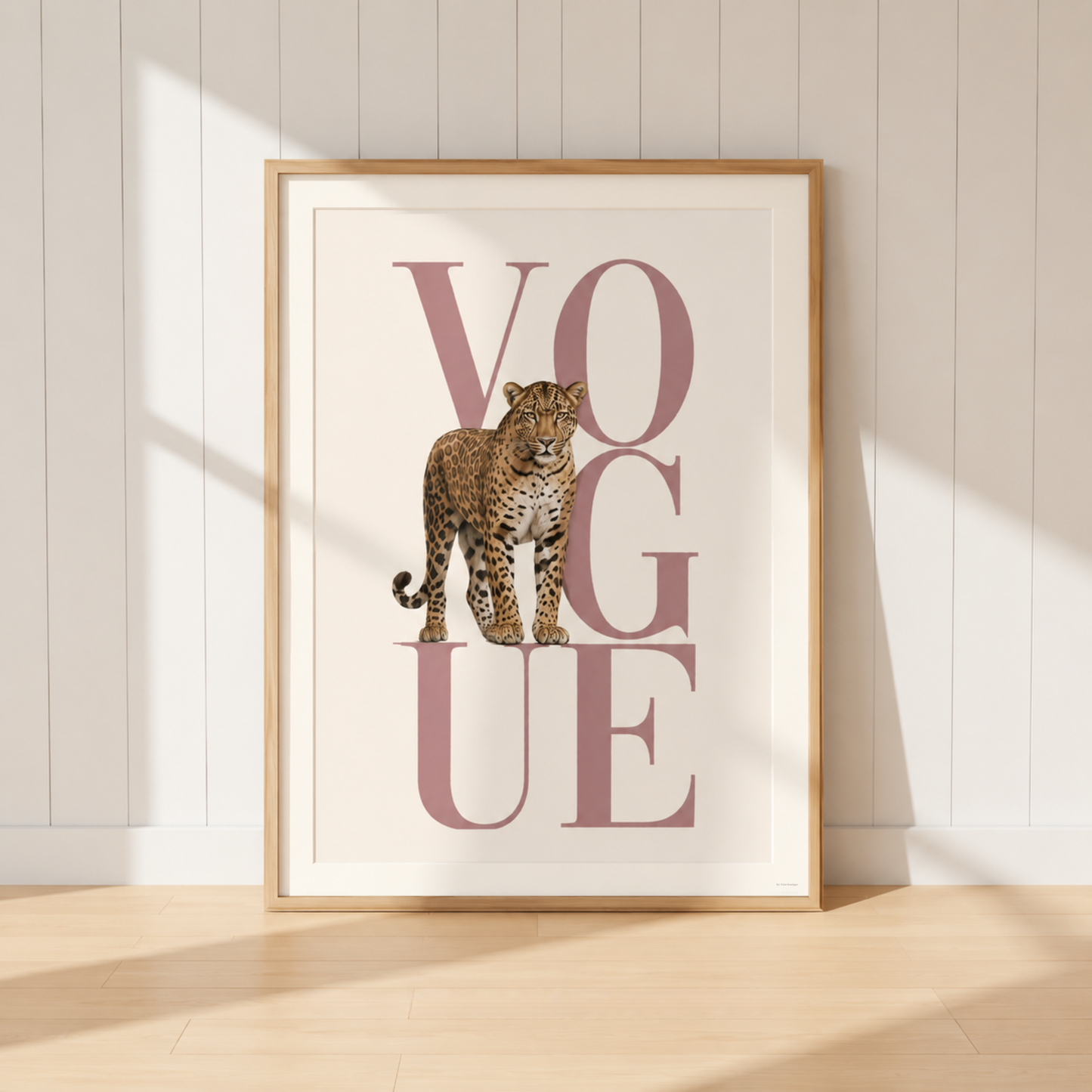 Luxury leopard Vogue print displayed on a blush pink and gold dressing room sideboard with designer books and neutral decor.
