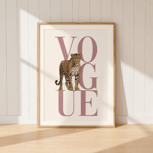 Luxury leopard Vogue print displayed on a blush pink and gold dressing room sideboard with designer books and neutral decor.
