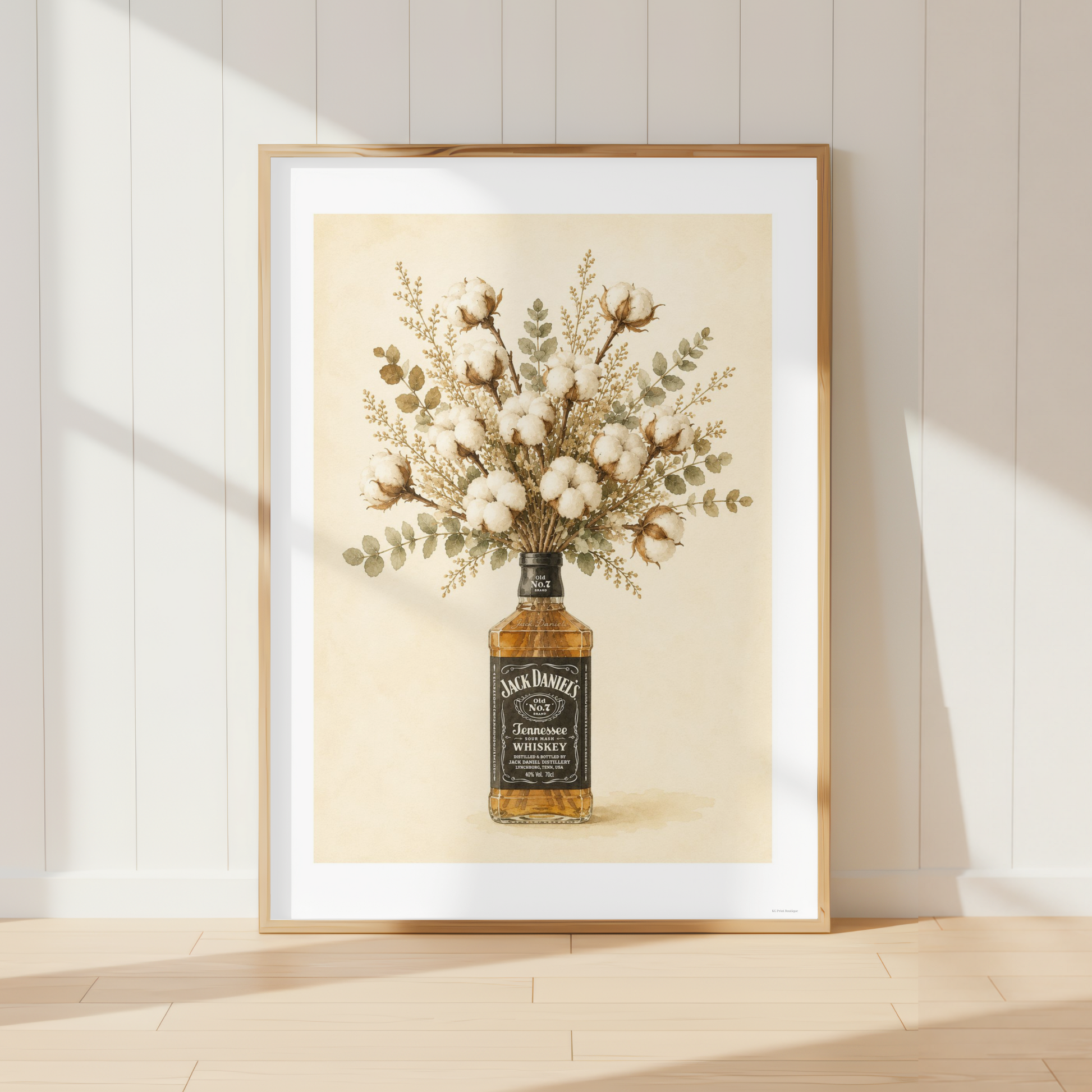 Rustic Jack Daniels wall art featuring a bouquet of soft cotton stems and eucalyptus arranged in a whiskey bottle. Neutral farmhouse botanical print perfect for country kitchens and dining rooms.