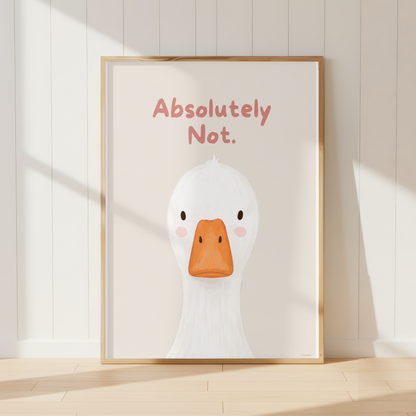 A framed art print featuring a cute white duck illustration with an orange beak and the text 'Absolutely Not.' in pink, leaning against a white paneled wall on a light wood floor.