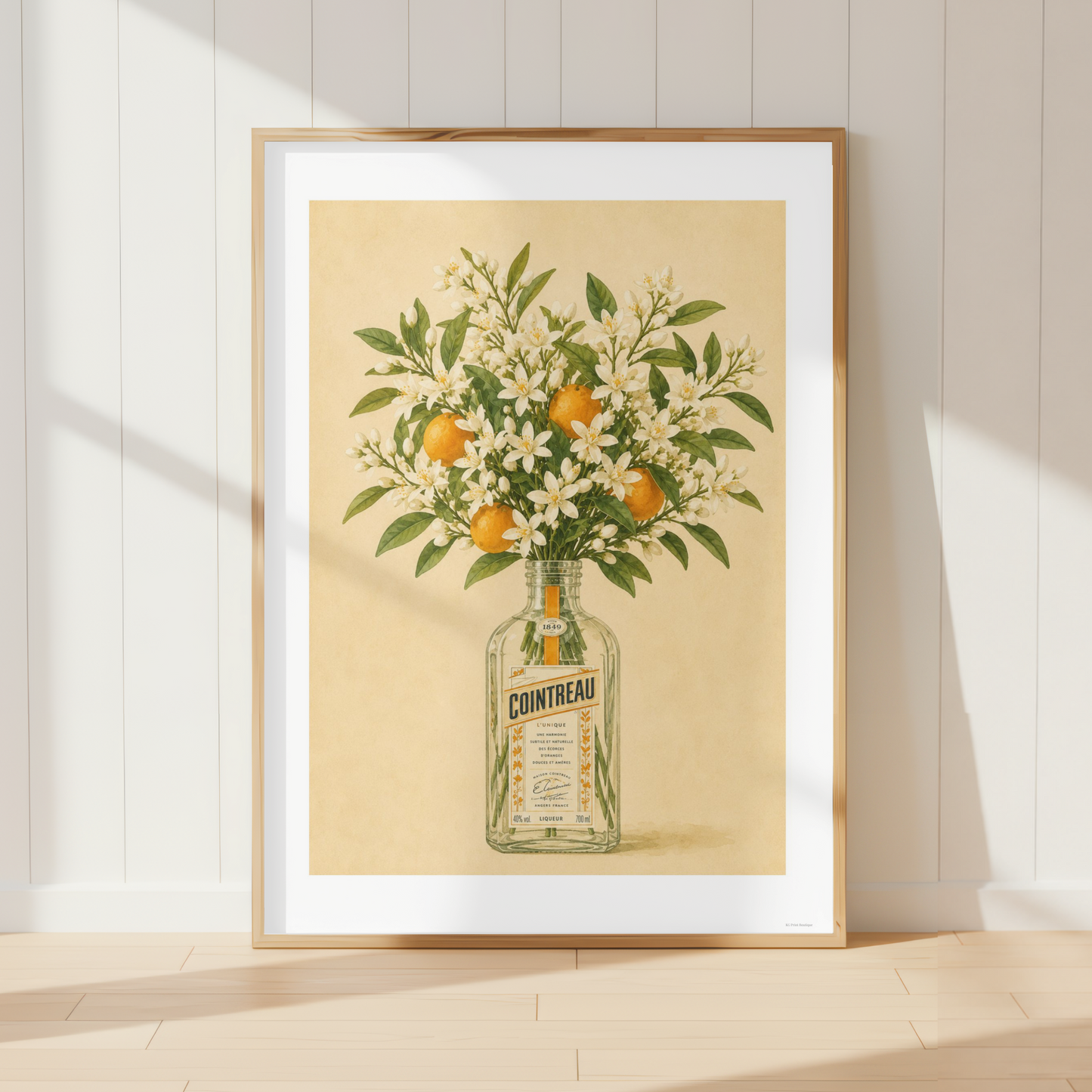 Vintage Cointreau botanical print featuring orange blossoms and citrus fruit in a Mediterranean kitchen interior.
