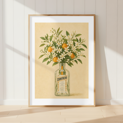 Vintage Cointreau botanical print featuring orange blossoms and citrus fruit in a Mediterranean kitchen interior.